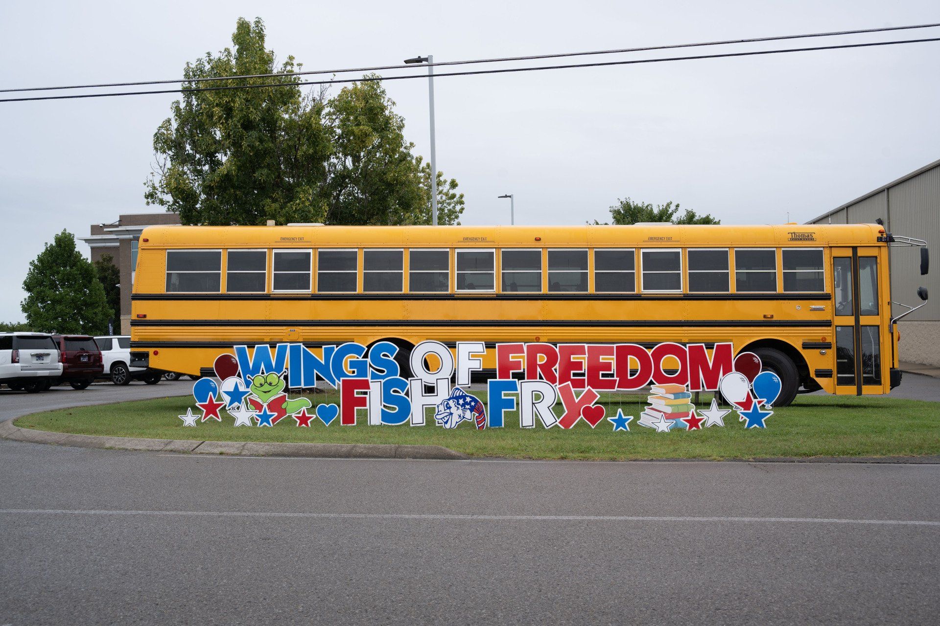 A yellow school bus with a sign that says wings of freedom