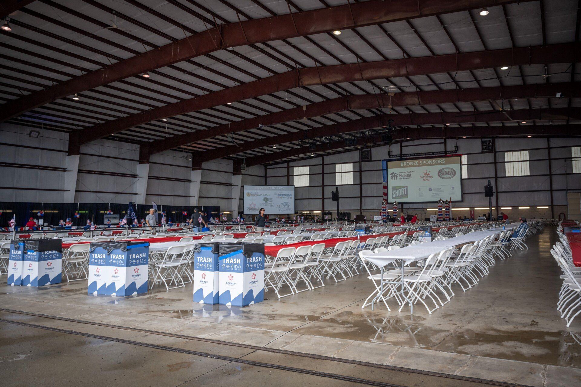 A large building with tables and chairs set up for an event