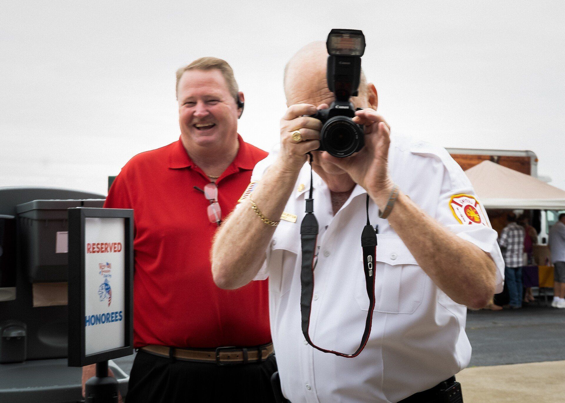 A man is taking a picture of another man with a camera.