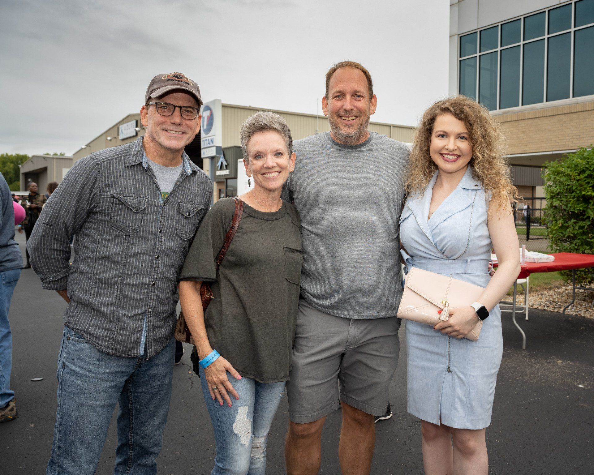 A group of people are posing for a picture in front of a building.