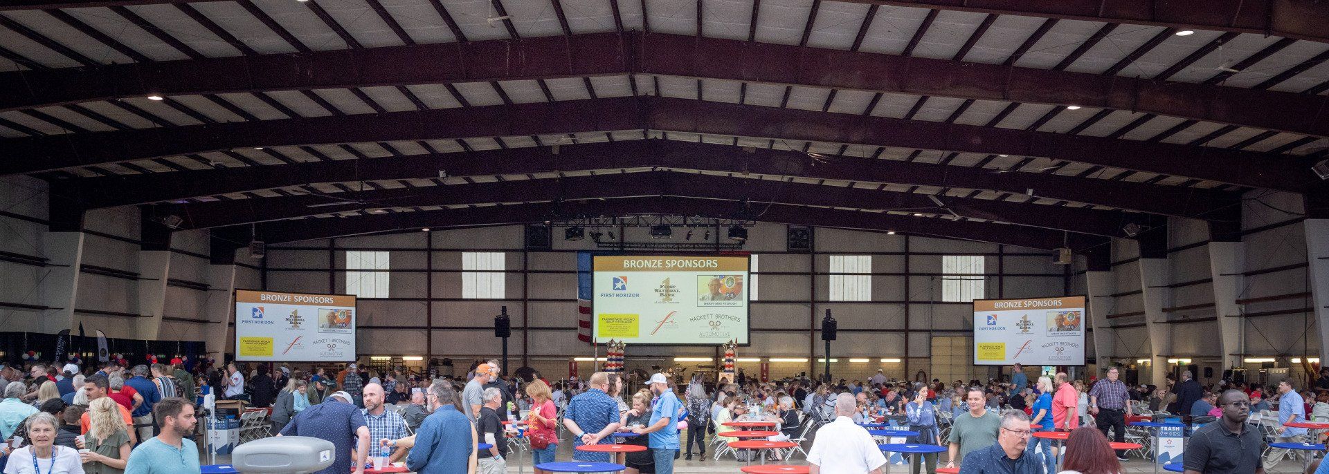 A large crowd of people are gathered in a large building.