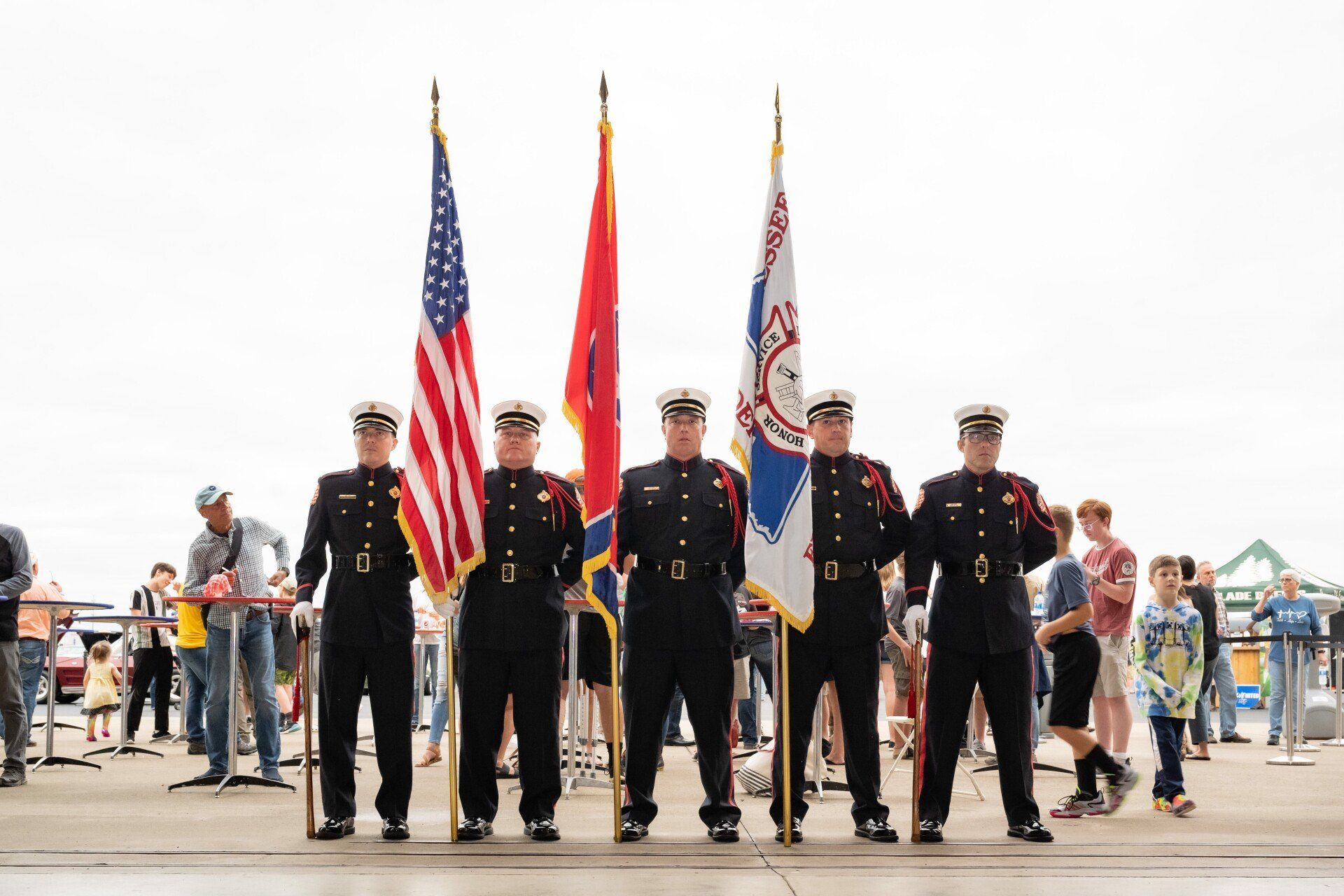 A group of men in military uniforms holding flags