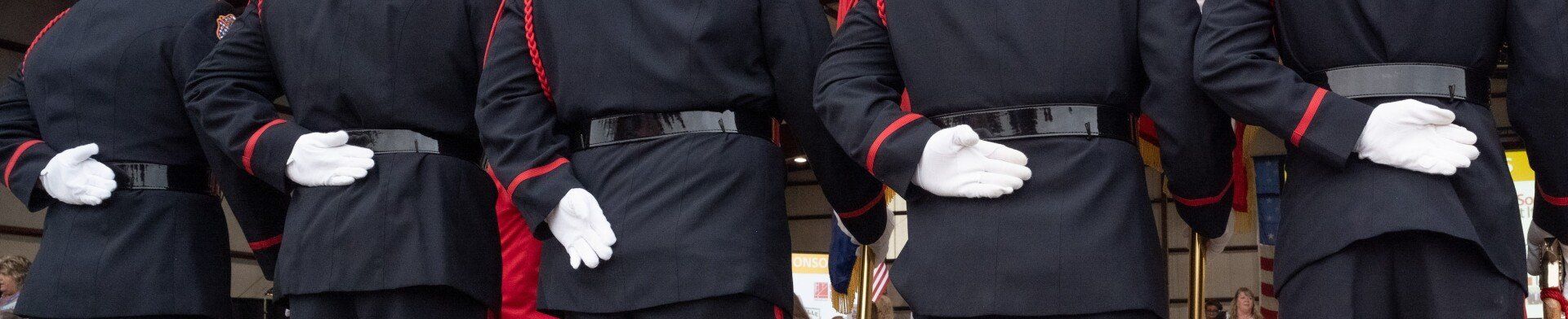 A group of men in military uniforms are standing in a line.