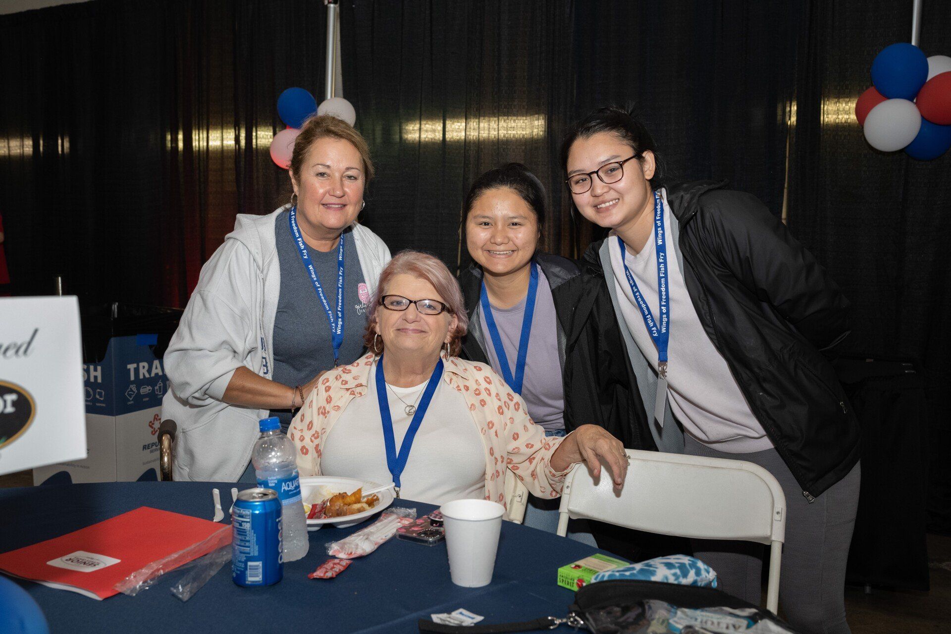 A group of women are posing for a picture at a table.
