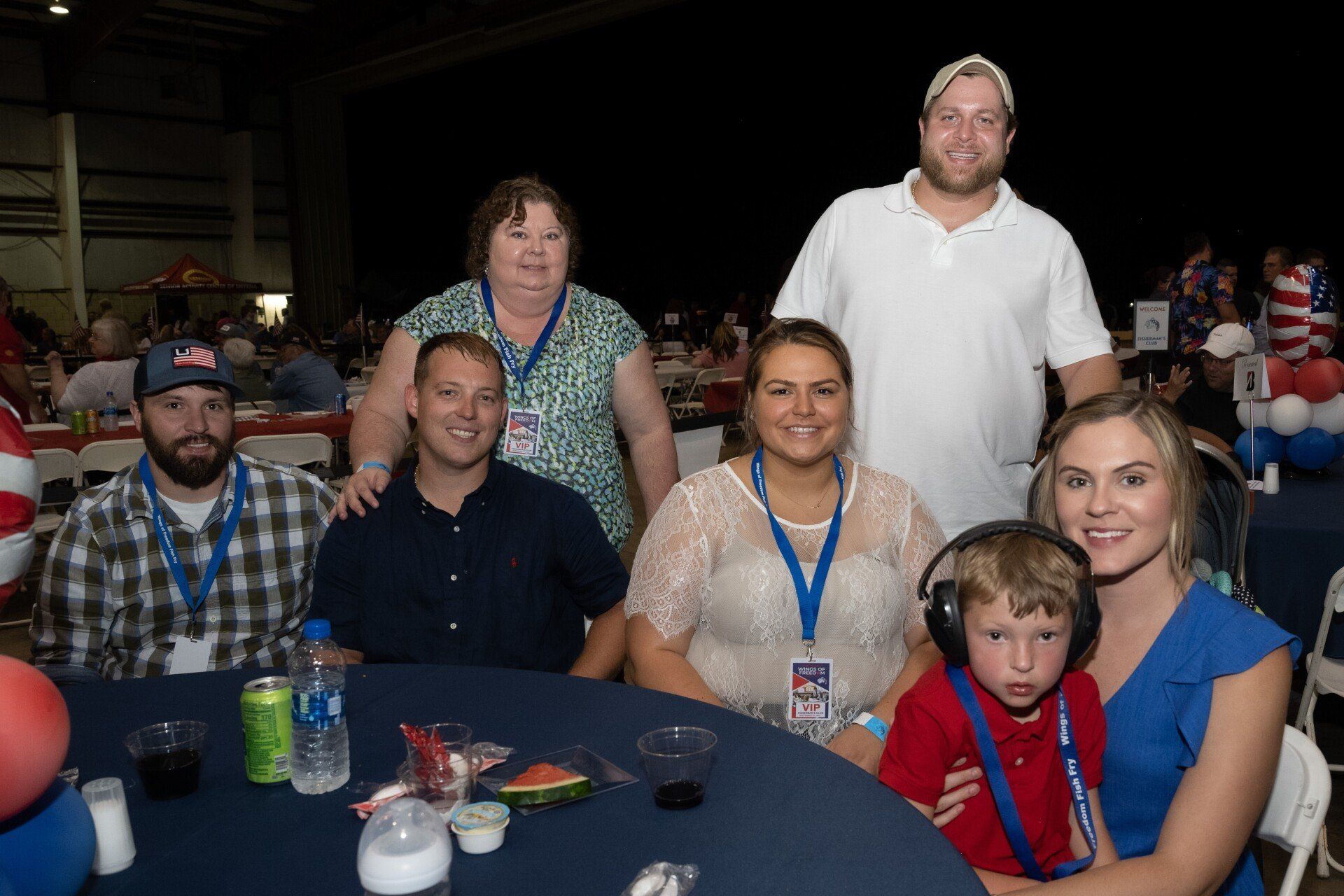 A group of people are sitting at a table with headphones on.