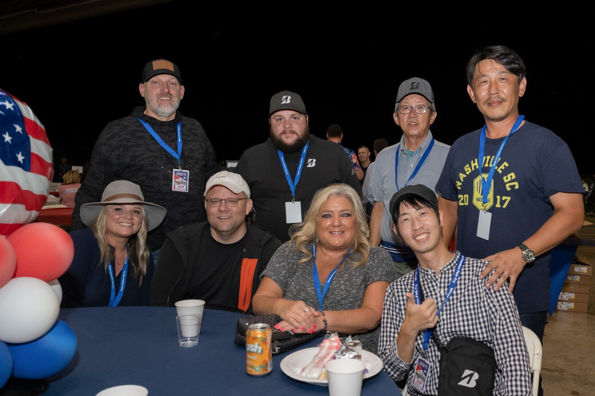 A group of people are posing for a picture at a table.