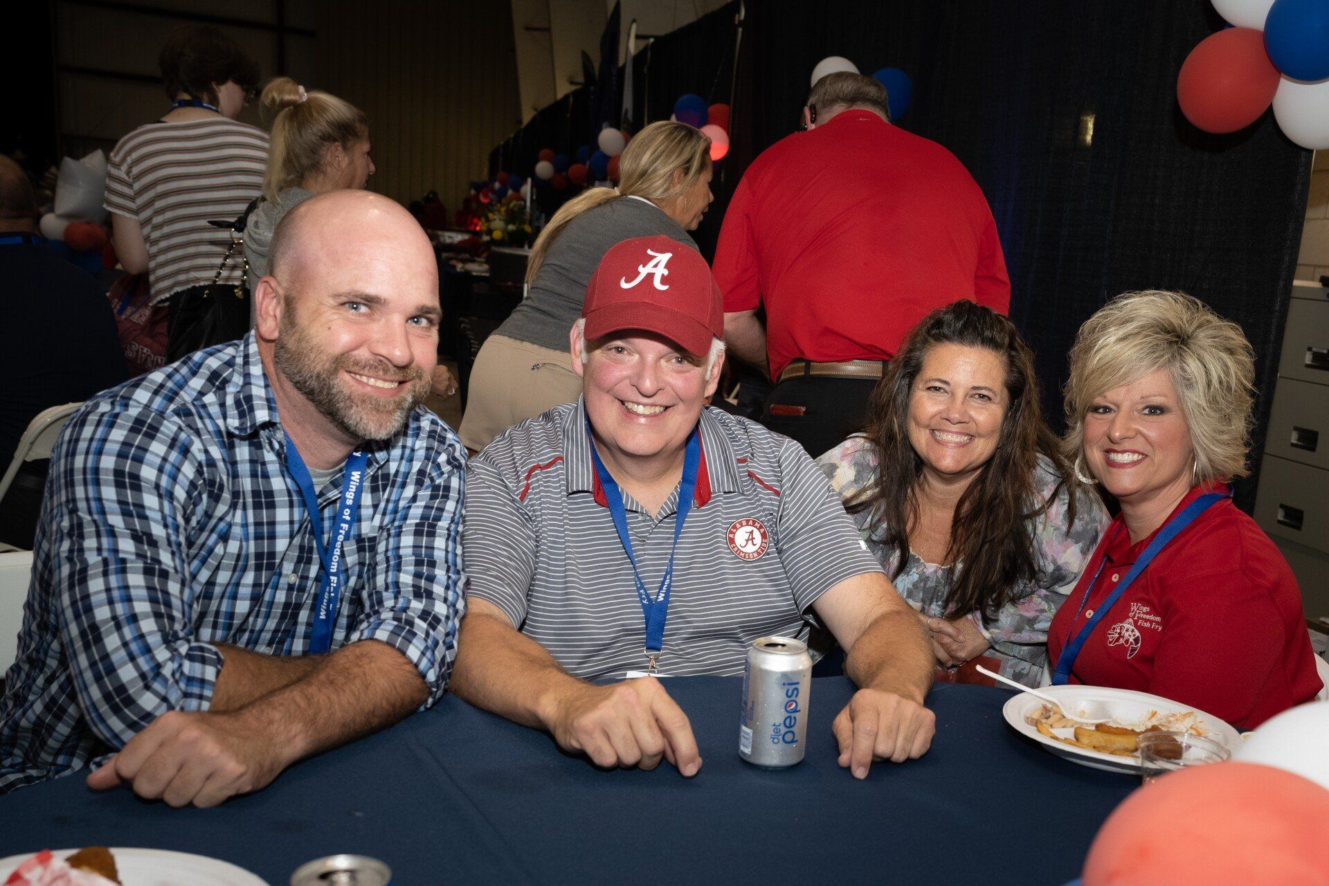 A group of people are posing for a picture at a table.