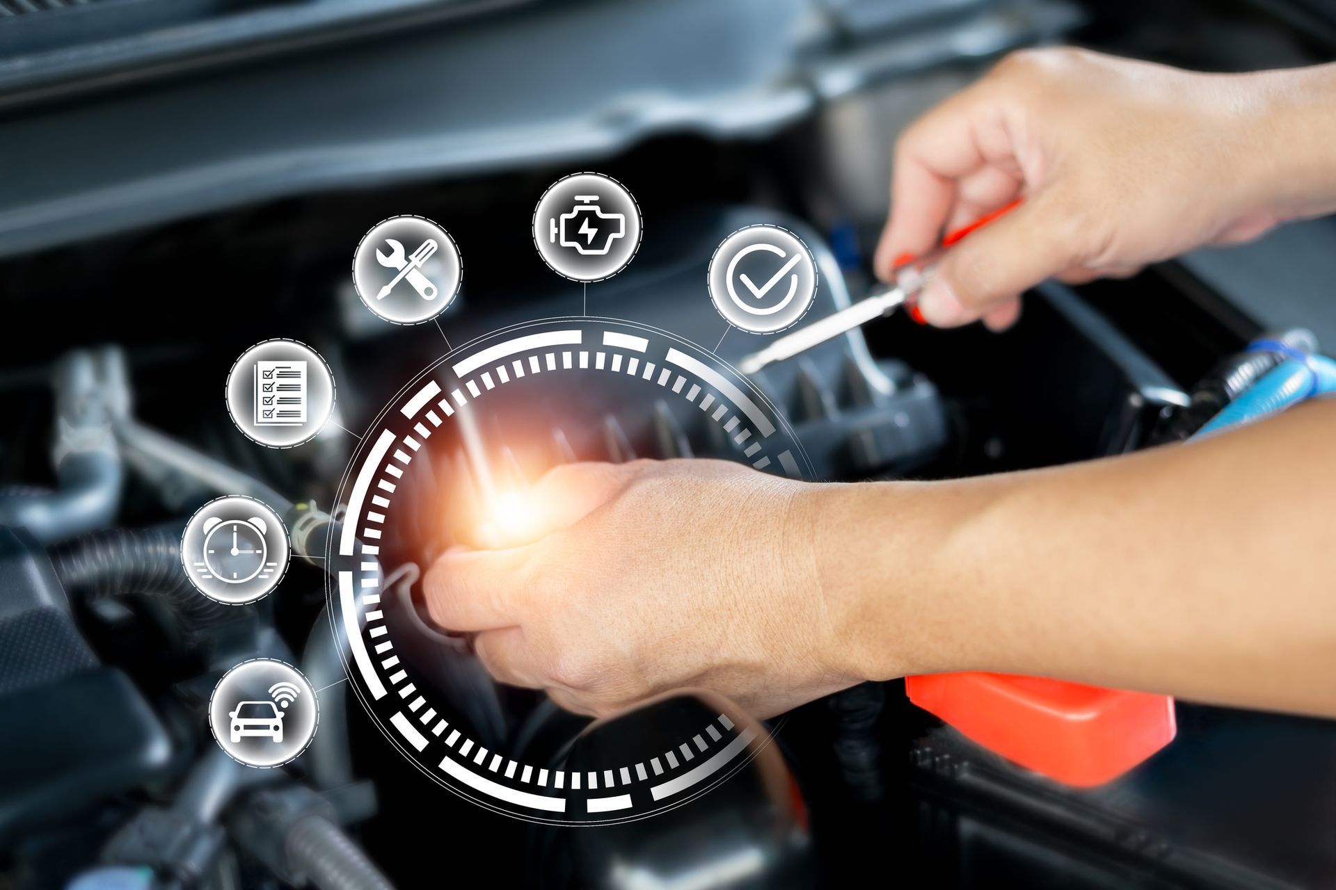 A person is working on a car with a screwdriver. A person is working on a car with a screwdriver.