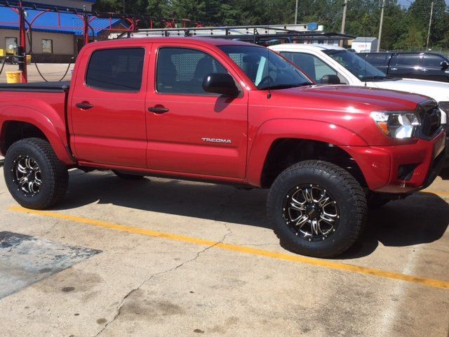 A red truck is parked in a parking lot