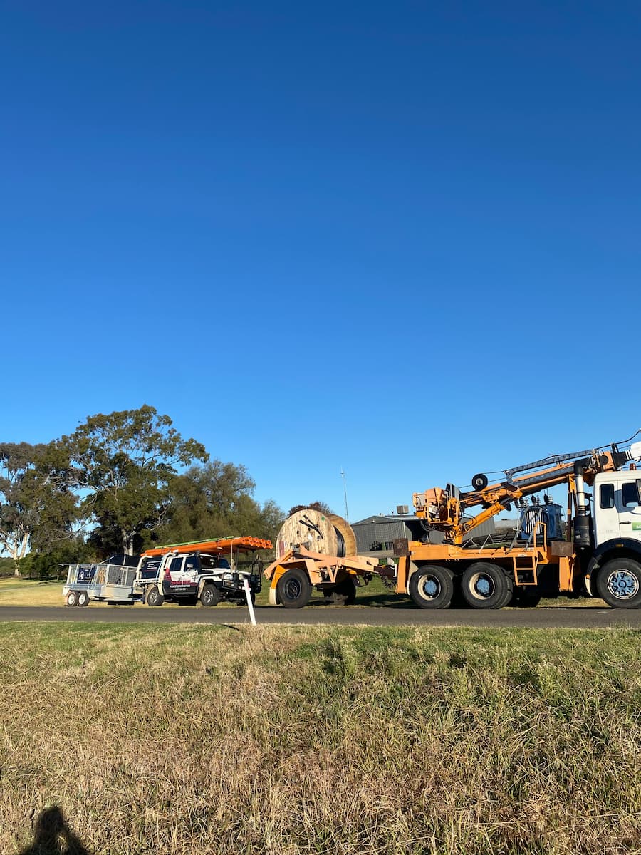 Electric Utility Trucks Parked On-Site — Central West Power Construction in Orange, NSW