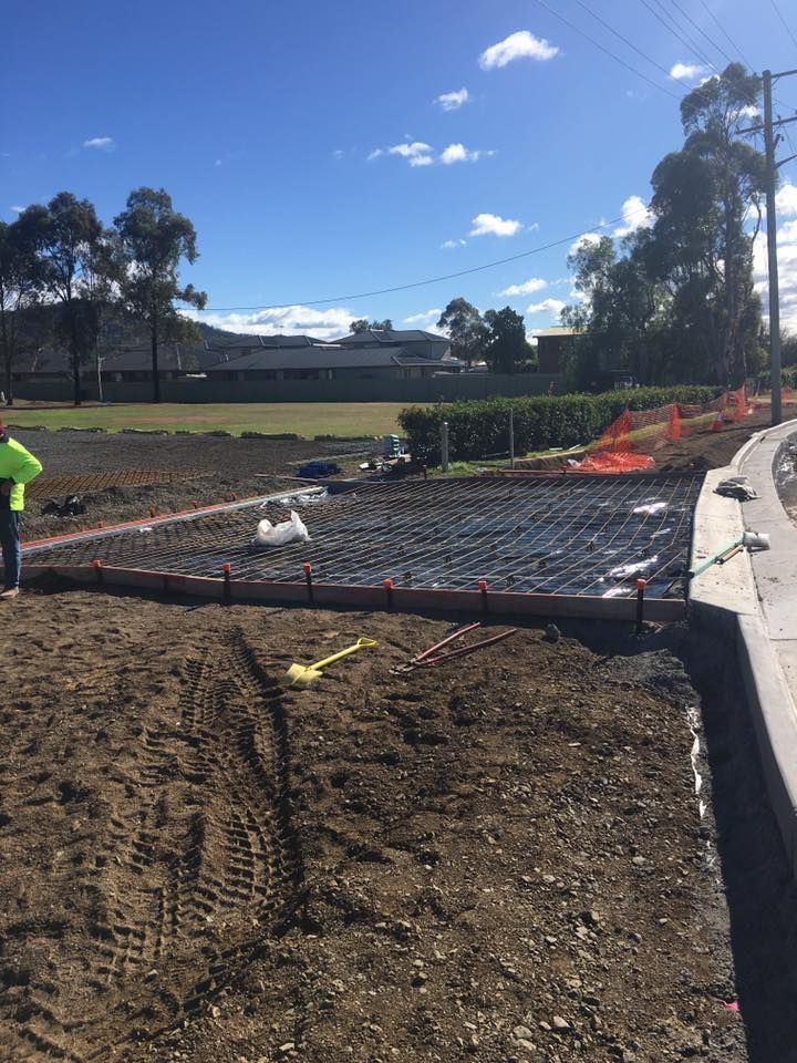 A Man is Standing in the Middle of a Dirt Field — LVL Constructions in Newcastle, NSW