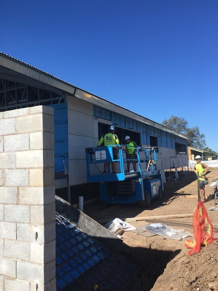 A Group of Construction Workers Are Working on a Building — LVL Constructions in Newcastle, NSW