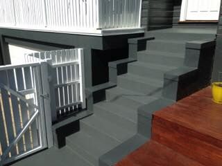A Wooden Deck With Stairs Leading Up to It and a Gate — LVL Constructions in Newcastle, NSW