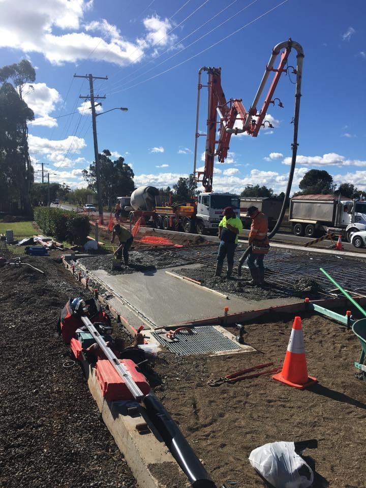 A Concrete Pump is Being Used to Pour Concrete on a Sidewalk — LVL Constructions in Newcastle, NSW