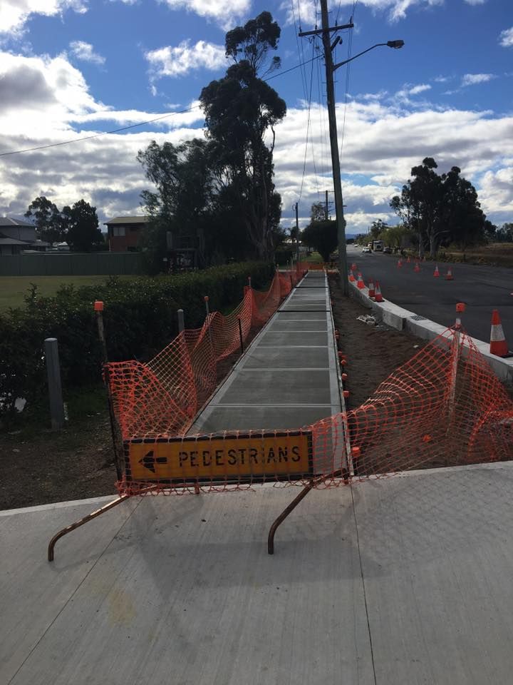 A Yellow Sign on the Side of a Road Says Pedestrians — LVL Constructions in Newcastle, NSW