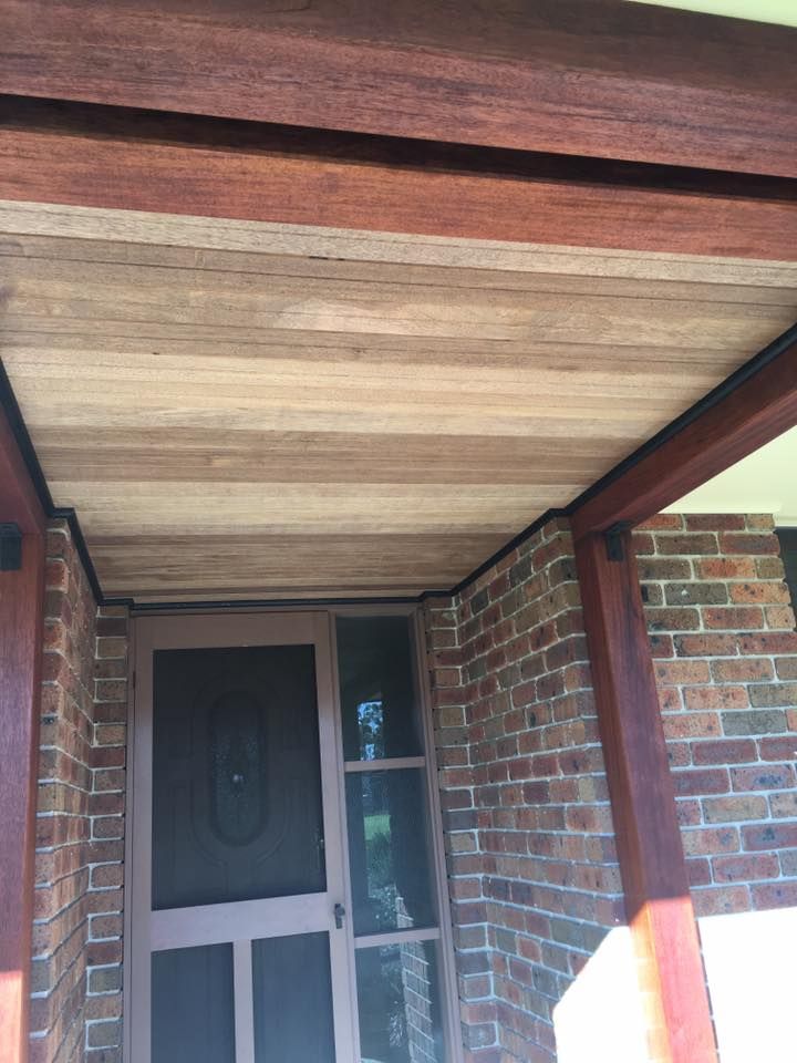 A Brick Building With a Wooden Ceiling and a Screen Door — LVL Constructions in Newcastle, NSW