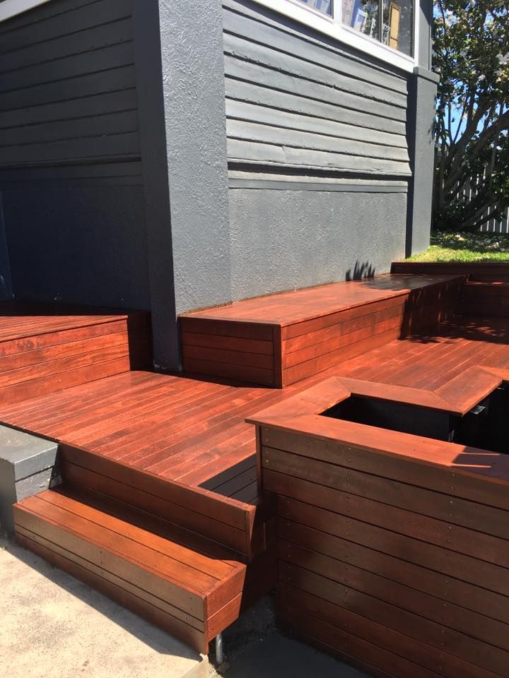 A Wooden Deck With Stairs and a Bench in Front of a House — LVL Constructions in Newcastle, NSW