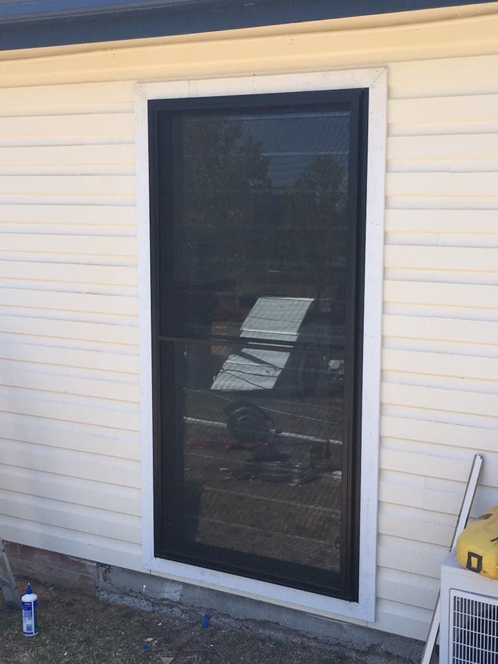 A White House With a Large Window on the Side of It — LVL Constructions in Newcastle, NSW