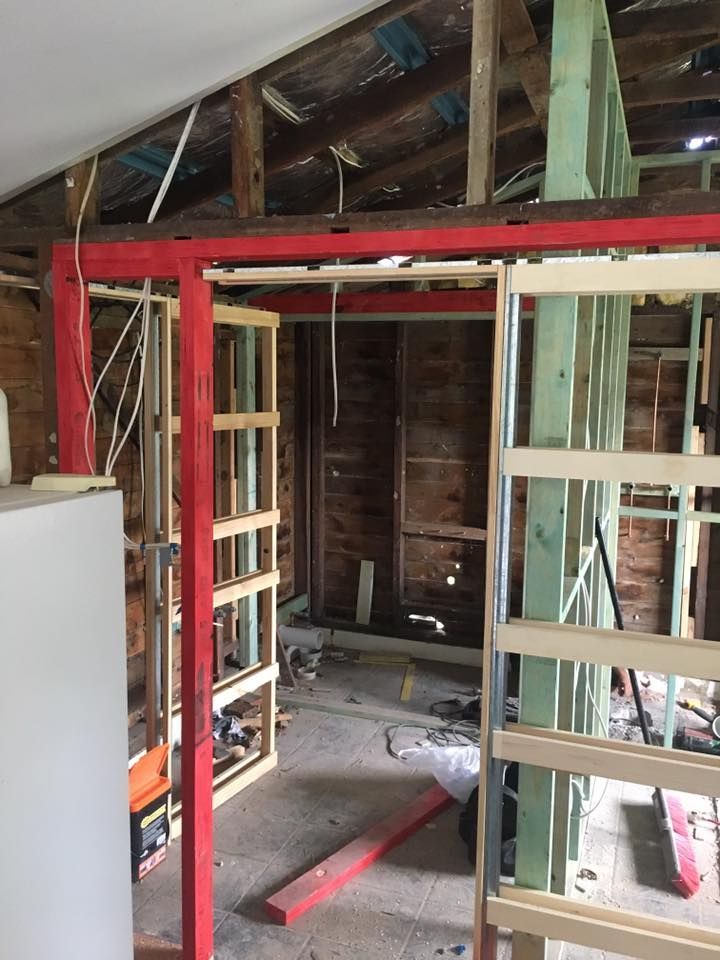 A Room Under Construction With a Red Frame and a White Refrigerator — LVL Constructions in Newcastle, NSW