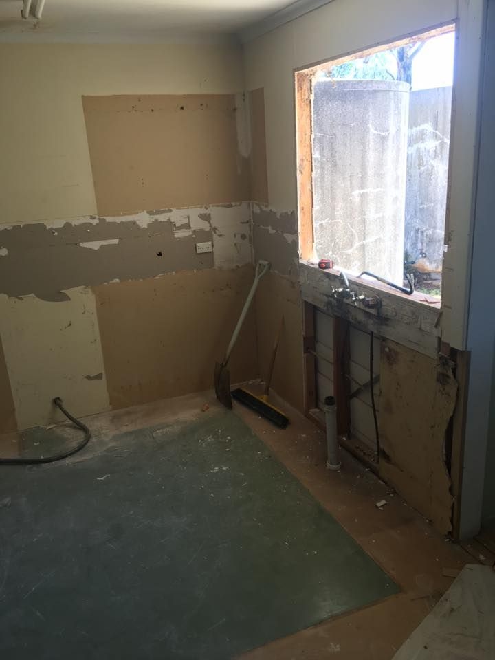 A Kitchen Under Construction With a Window and a Broom — LVL Constructions in Newcastle, NSW