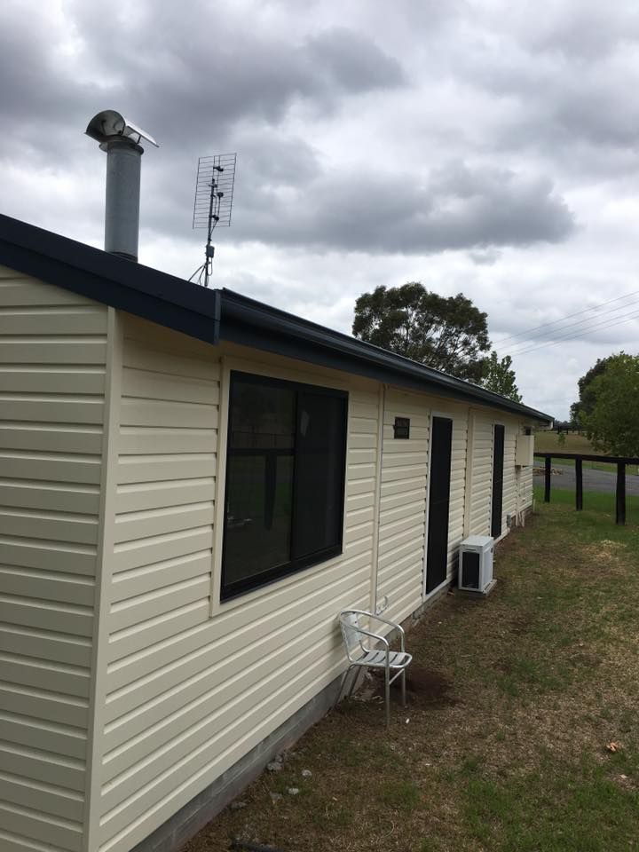 A White House With a Chimney on Top of It — LVL Constructions in Newcastle, NSW