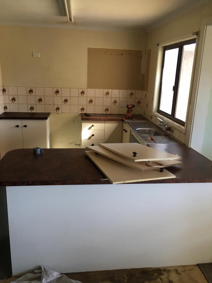 An Empty Kitchen With a Sink and a Window — LVL Constructions in Newcastle, NSW