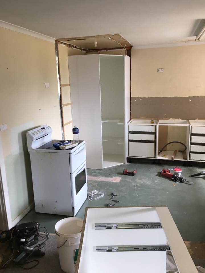 A Kitchen Under Construction With a Stove and Cabinets — LVL Constructions in Newcastle, NSW