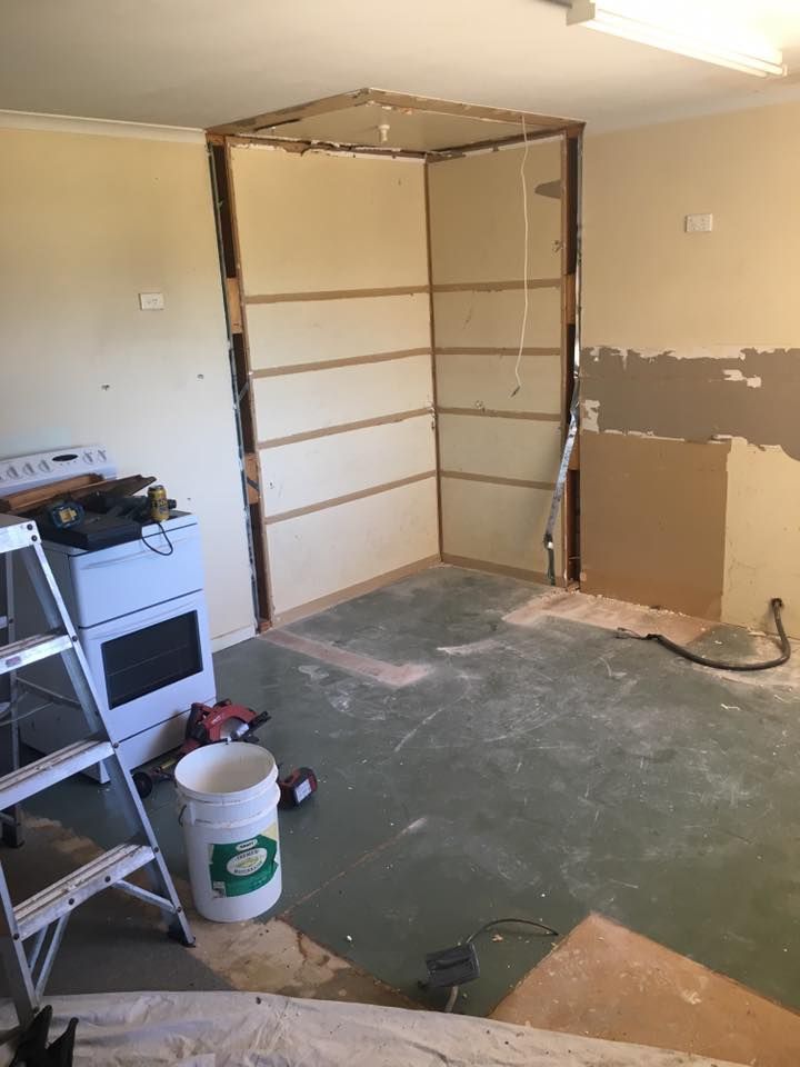 A Kitchen Under Construction With a Ladder and a Bucket of Paint — LVL Constructions in Newcastle, NSW