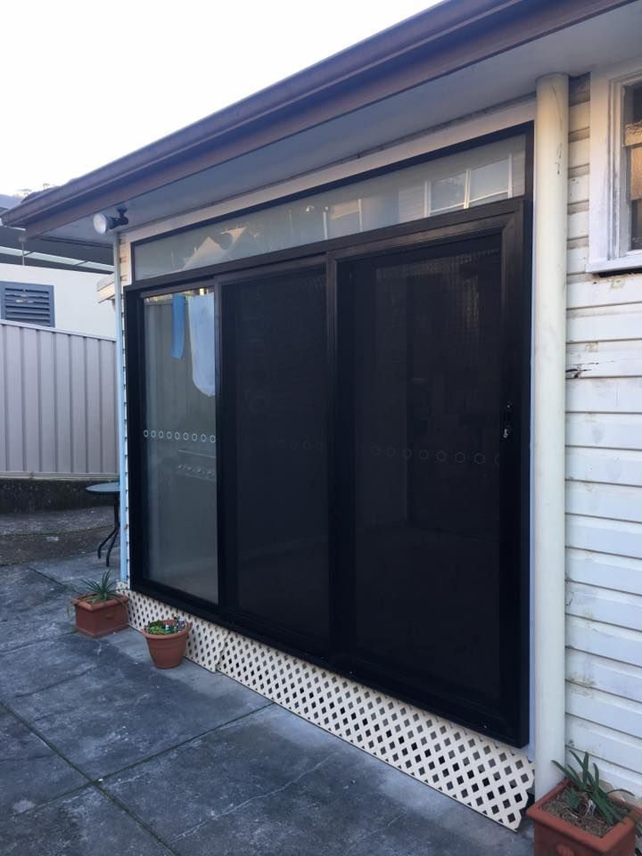 A White House With a Black Sliding Glass Door — LVL Constructions in Newcastle, NSW