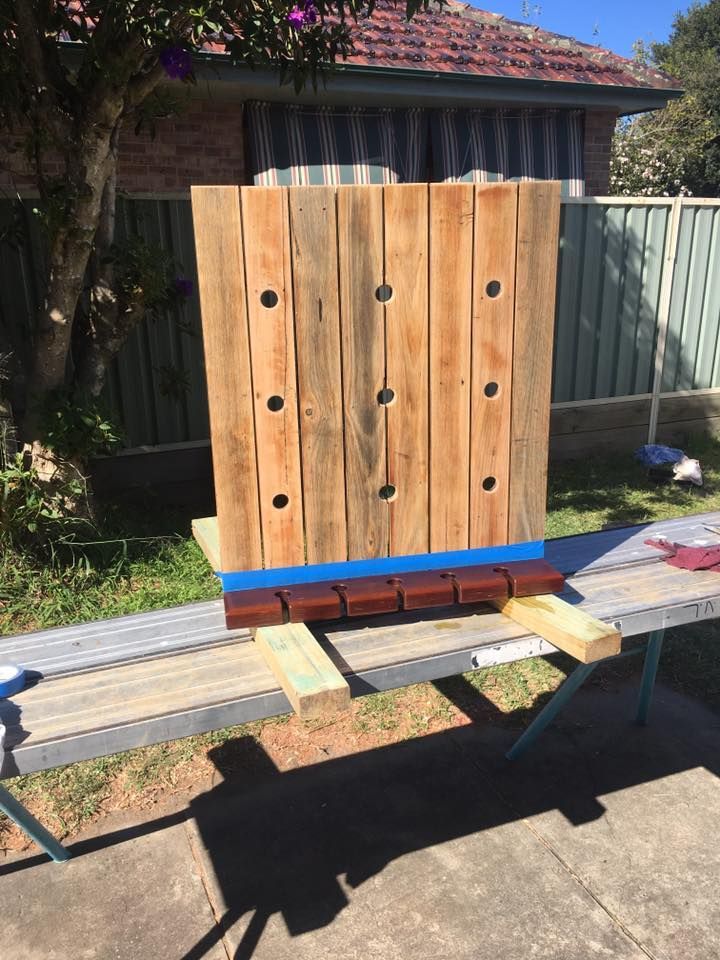 A Piece of Wood With Holes in It is Sitting on Top of a Bench — LVL Constructions in Newcastle, NSW