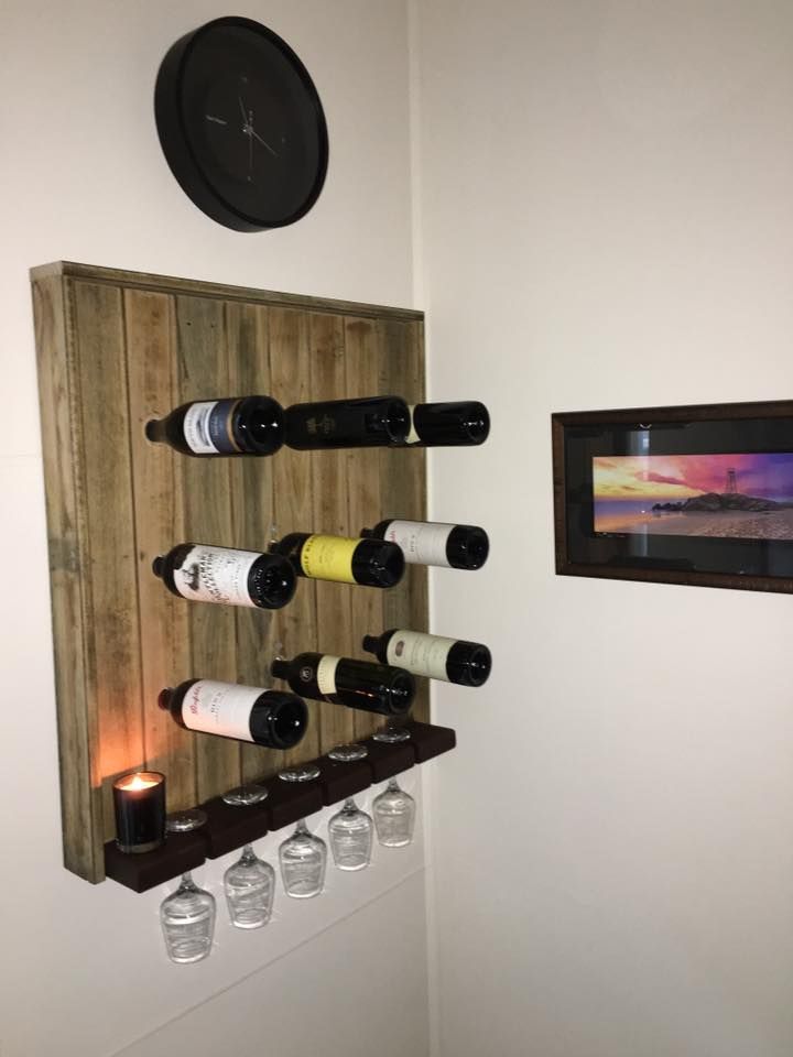 A Wooden Wine Rack With Wine Bottles and Wine Glasses on It — LVL Constructions in Newcastle, NSW