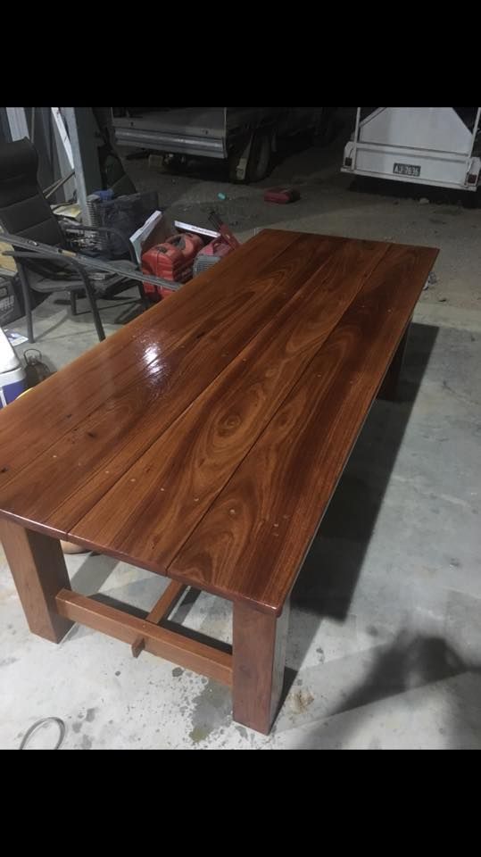 A Wooden Table is Sitting on Top of a Concrete Floor in a Garage — LVL Constructions in Newcastle, NSW