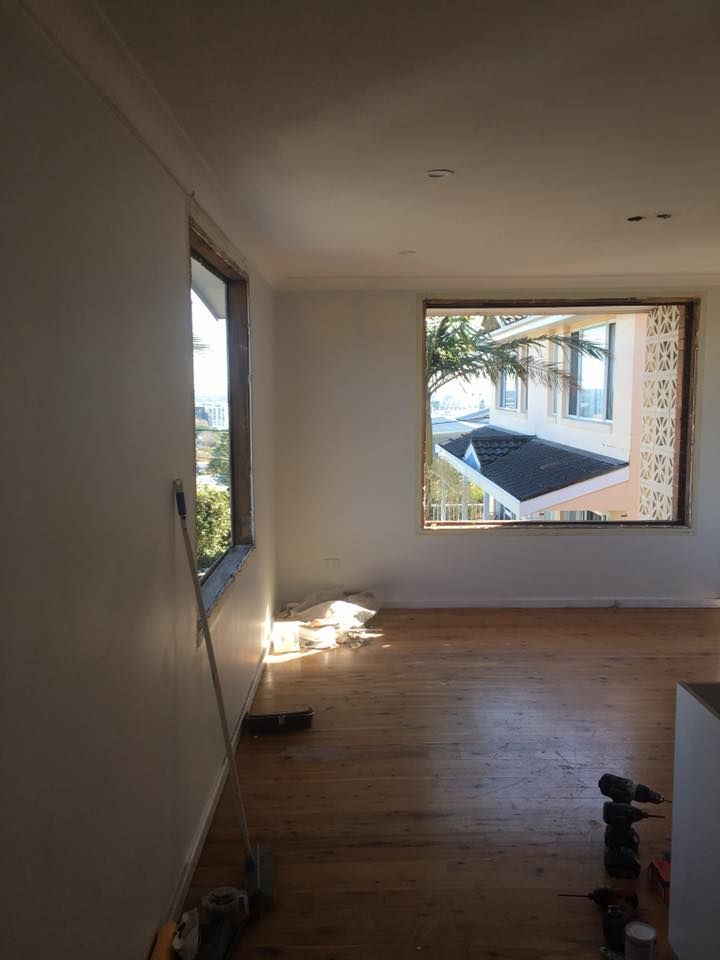 An Empty Room With a Window and a Wooden Floor — LVL Constructions in Newcastle, NSW