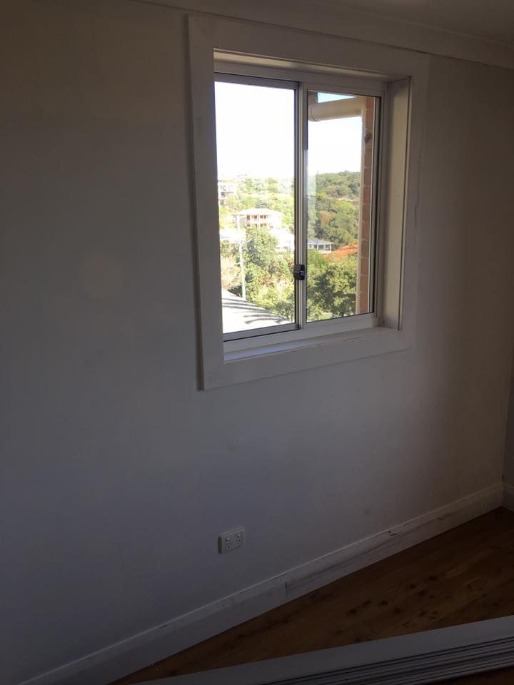 An Empty Room With a Window and a Wooden Floor — LVL Constructions in Newcastle, NSW