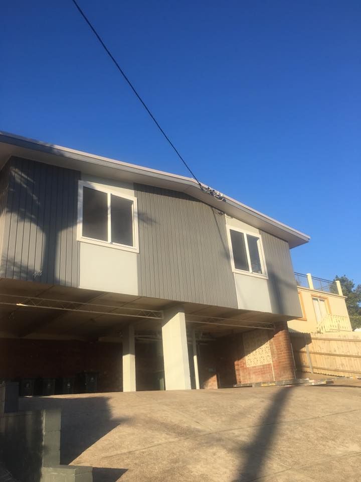 A House With a Lot of Windows and a Blue Sky in the Background — LVL Constructions in Newcastle, NSW