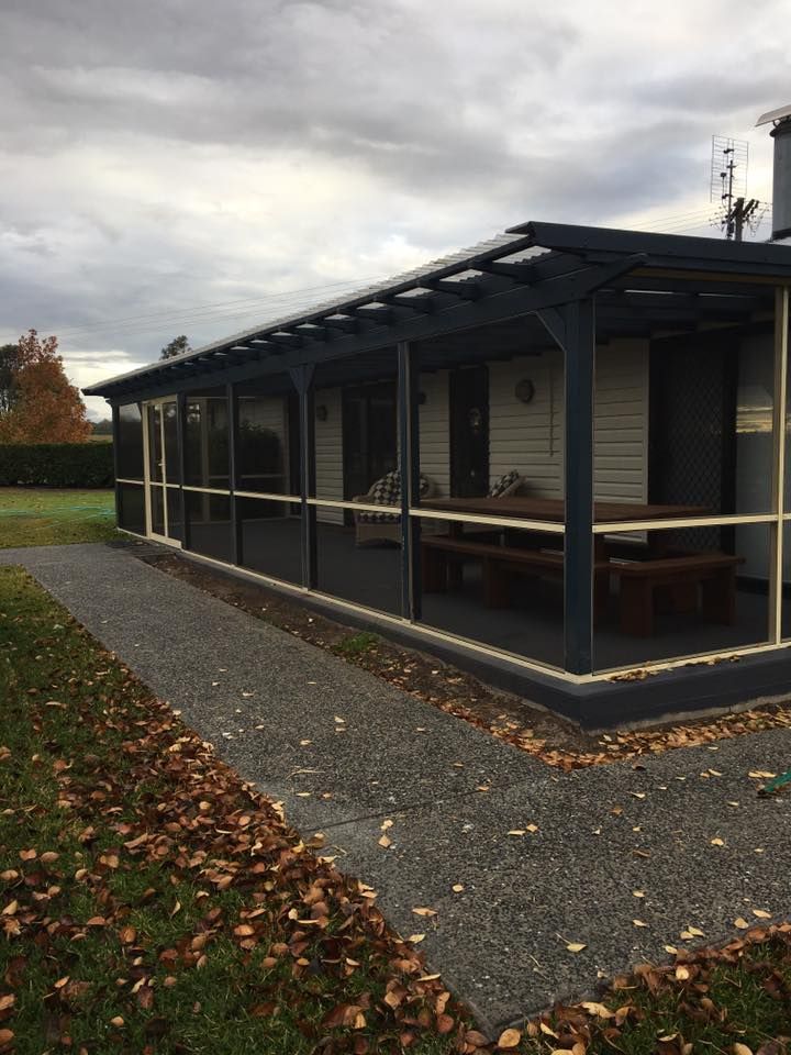 A House With a Porch and a Picnic Table in Front of It — LVL Constructions in Newcastle, NSW