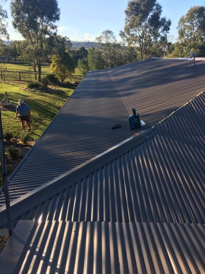 A Man is Standing on the Roof of a House — LVL Constructions in Newcastle, NSW