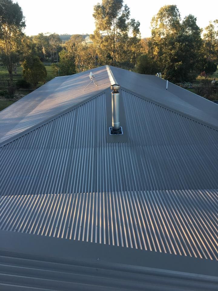A Roof With a Chimney on It and Trees in the Background — LVL Constructions in Newcastle, NSW