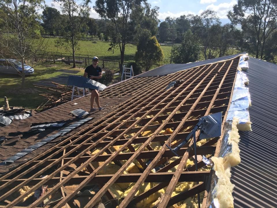 A Man is Standing on the Roof of a House — LVL Constructions in Newcastle, NSW
