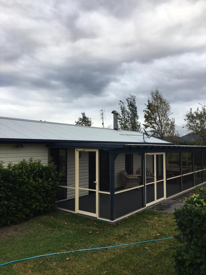 A House With a Screened in Porch on a Cloudy Day — LVL Constructions in Newcastle, NSW