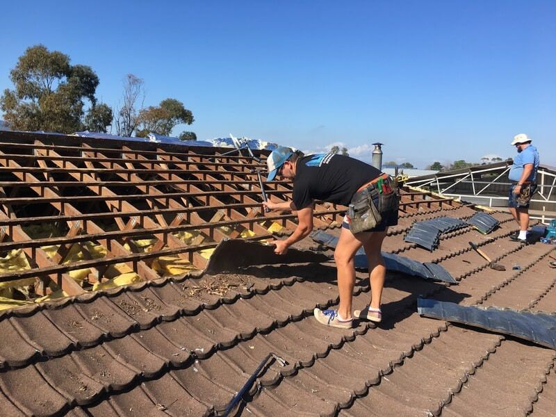 A Man and a Woman Are Working on a Roof — LVL Constructions in Newcastle, NSW