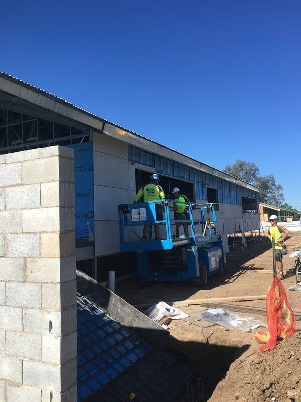 A Group of Construction Workers Are Working on a Building — LVL Constructions in Newcastle, NSW