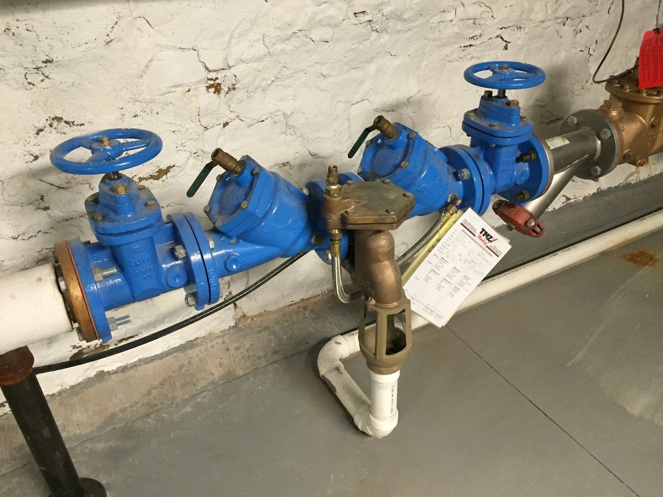 A bunch of pipes with blue valves are connected to each other.