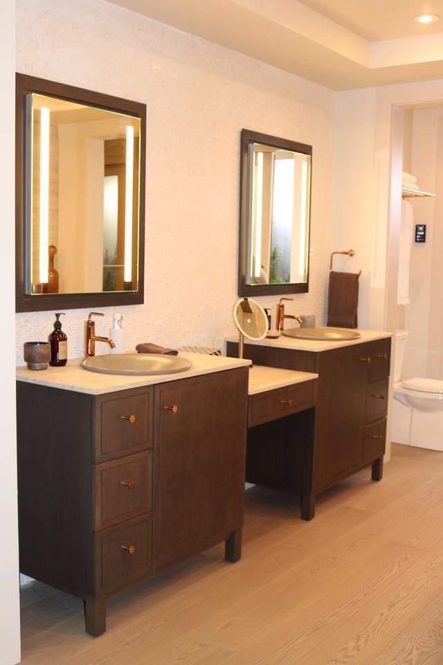A bathroom with two sinks and two mirrors