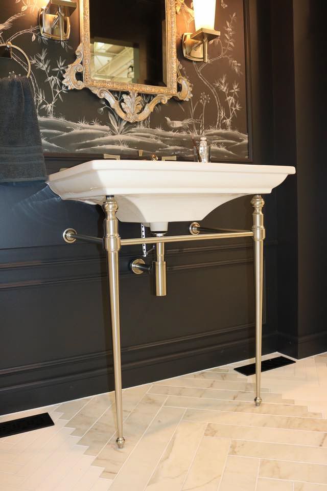 A bathroom with a sink and a mirror on the wall.