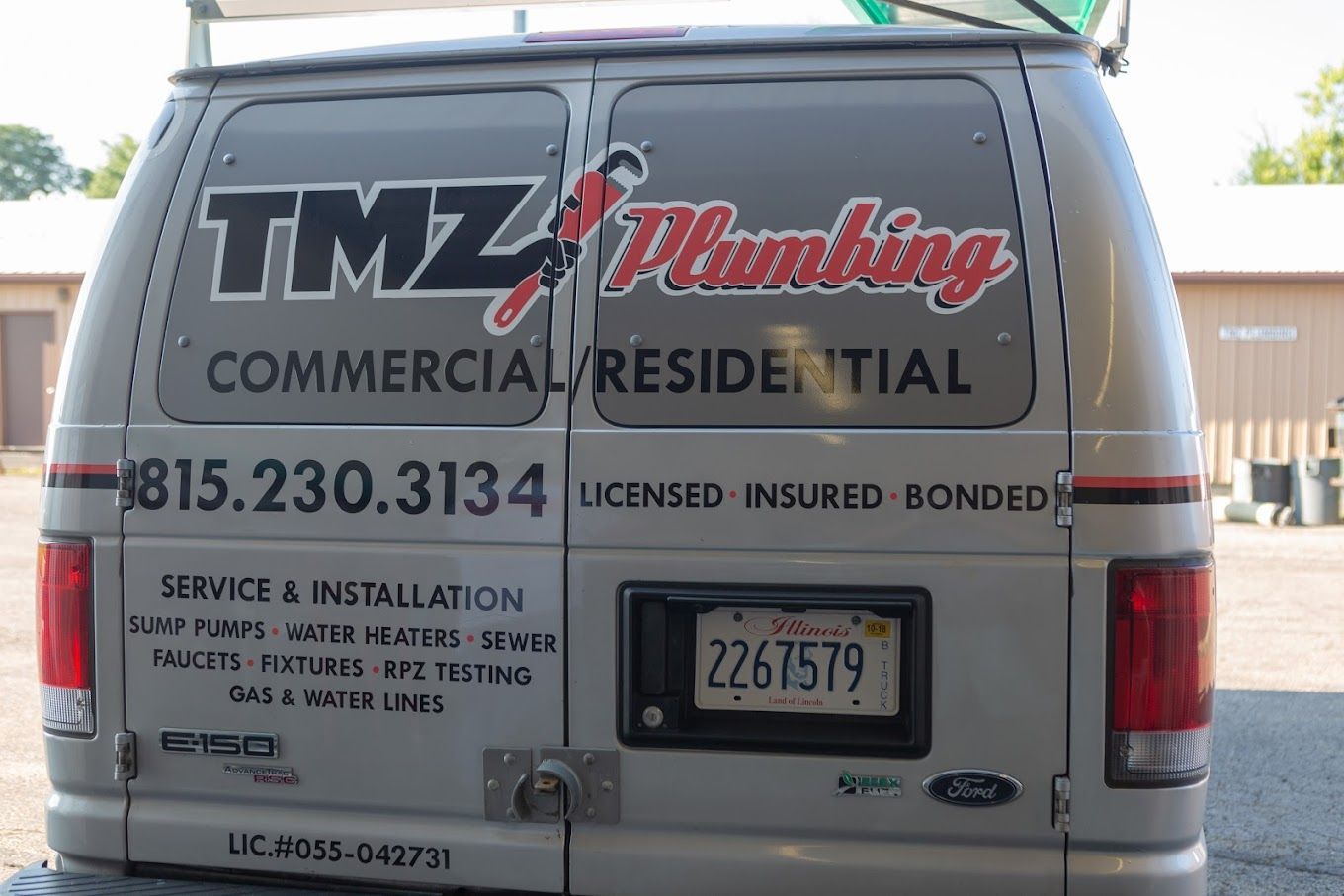 The back of a van that says tmz plumbing on it