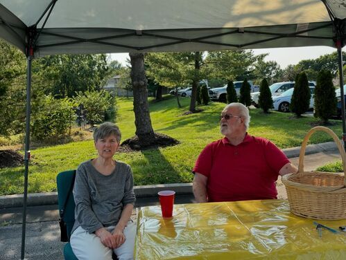 Two People Sitting Outside for Fairview Church of Christ's Back to School Event