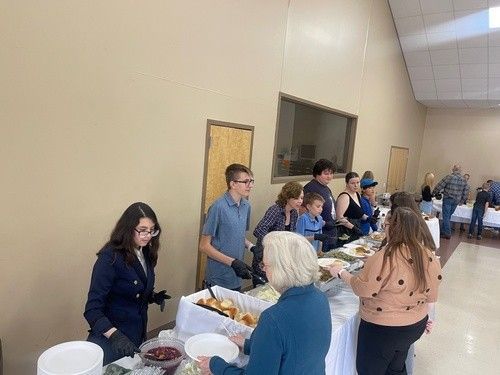 A Line of People Plating Their Food at Fairview Church of Christ's Thanksgiving Community Dinner