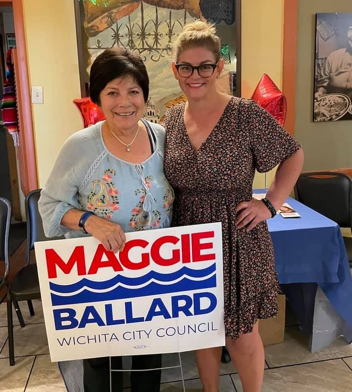 Maggie Ballard smiling with a supporter proudly holding a Maggie Ballard for Wichita City Council yard sign.