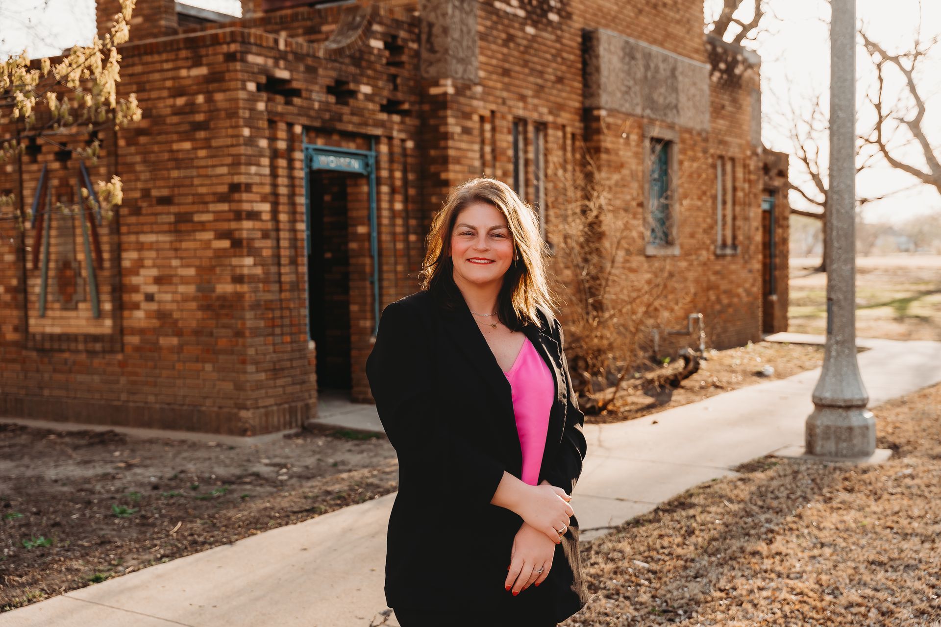 Maggie Ballard smiling while standing with her son, Paxton, highlighting her family's connection to the community.